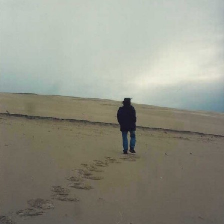 mitch walking in sand dunes in france towards who knows where